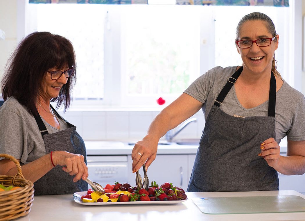Two cooks preparing fruit in the centre kitchen